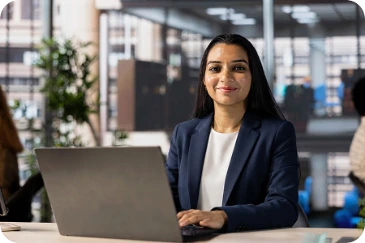 Trainee working at a laptop in an office