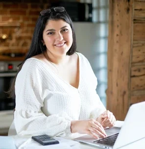 An operations professional working on her laptop